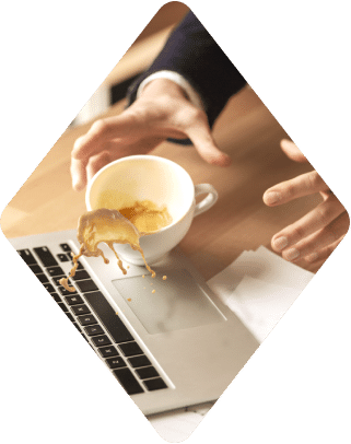 Coffee spilling onto a laptop