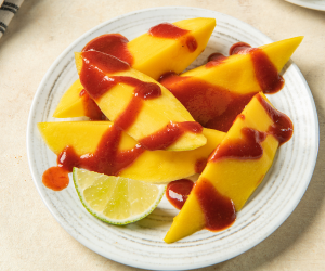 mango slices with chamoy sauce on top
